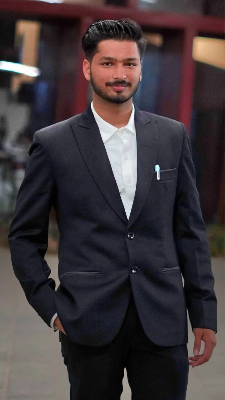 Anshum Singla in a navy blazer, smiling